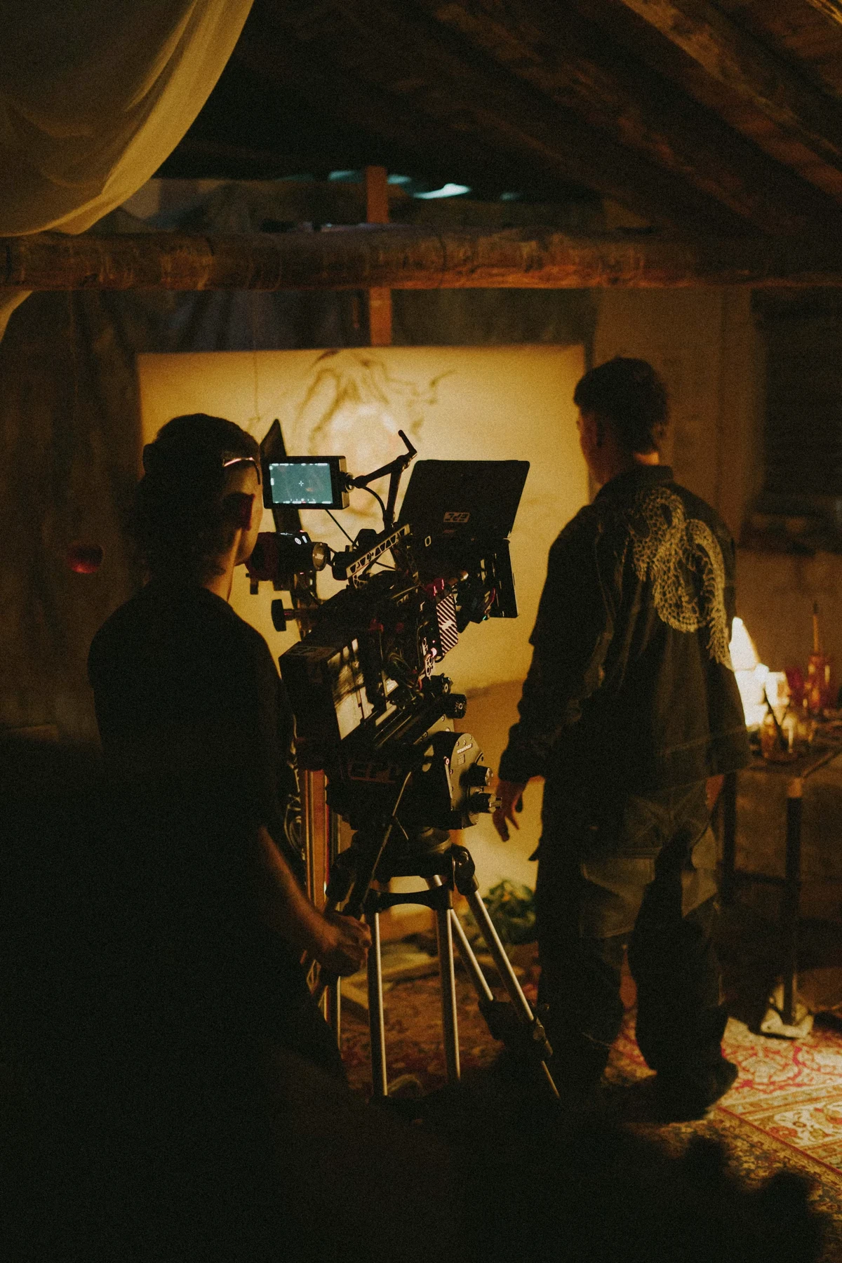 Film production crew composing a warmly lit scene
